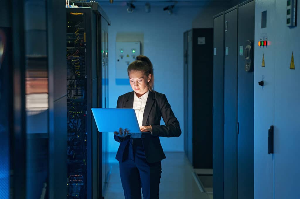 female IT engineer working in network server room detecting and responding to cybersecurity needs